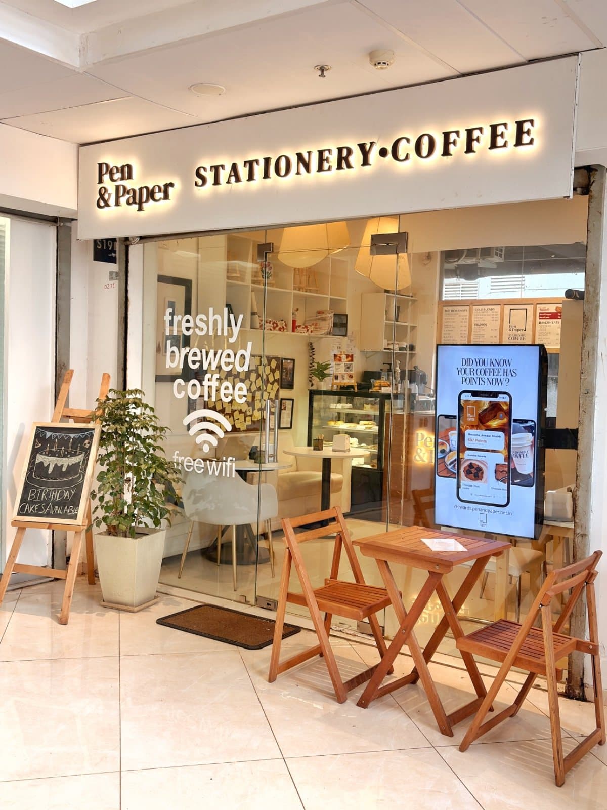 Inside Stationery Coffee: open shelves, a pastry counter and seating beyond the glass front.